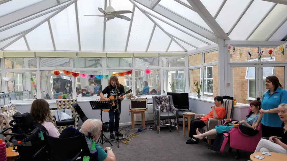People listening to a musician in a conservatory