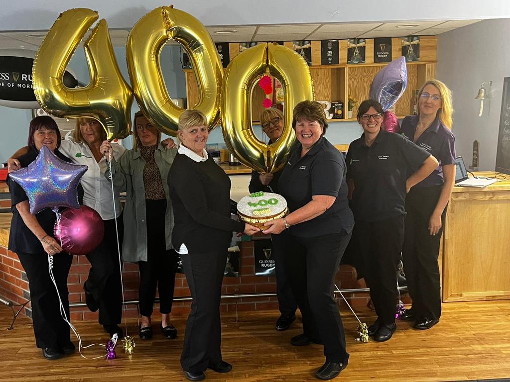 Team with 400 balloons and cakes