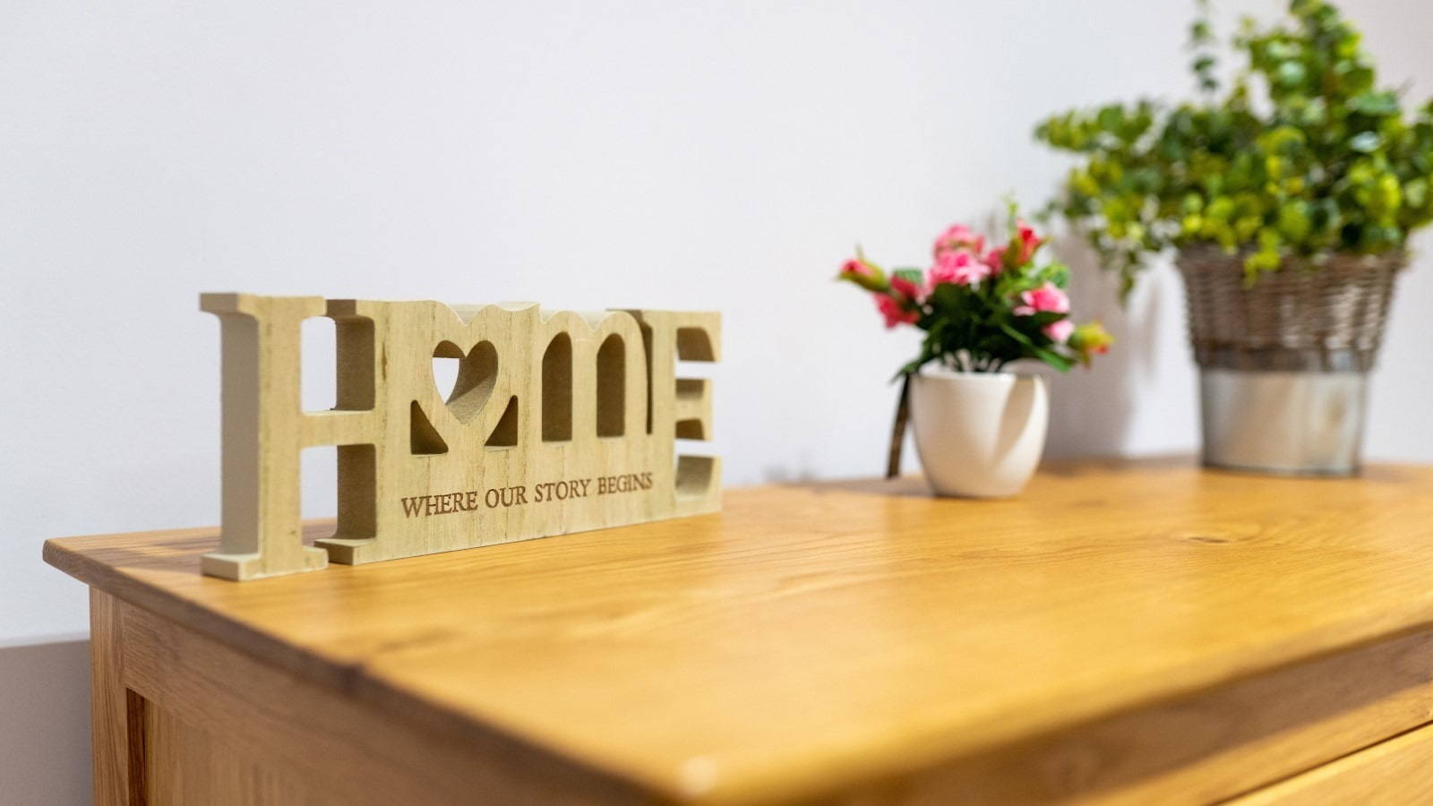 Home sign on a table with flowers